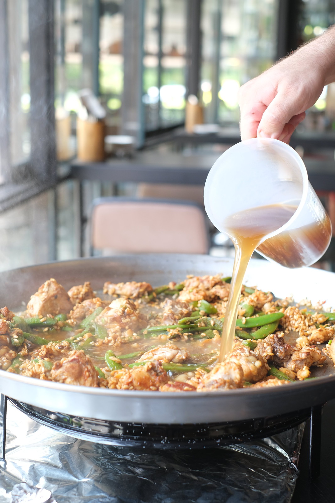 World Paella Day - Pouring Stock